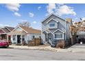 Inviting gray two-story home with classic design, complemented by a well-maintained front yard at 4445 Pearl St, Denver, CO 80216