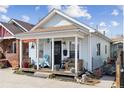 Charming bungalow with a cozy front porch, ideal for relaxing and enjoying the neighborhood ambiance at 4445 Pearl St, Denver, CO 80216