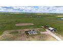 Expansive aerial view of the property with a house, barn, and large open fields with mountain views at 6201 S Vanderhoof St, Bennett, CO 80102