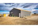 Spacious and well-maintained metal garage with ample storage space for vehicles and equipment at 6201 S Vanderhoof St, Bennett, CO 80102