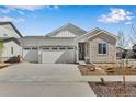 Charming single Gathering home featuring a three car garage, stone accents, and manicured landscaping at 24593 E 34Th Ave, Aurora, CO 80019
