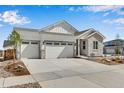 Charming single Gathering home featuring a three car garage, stone accents, and manicured landscaping at 24593 E 34Th Ave, Aurora, CO 80019