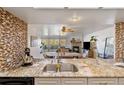 A bright kitchen leading into the dining and living room with a fireplace at 23694 Pondview Pl # B, Golden, CO 80401