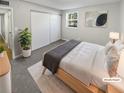 Staged bedroom featuring a light wood bed frame, large closet, and a view out of the window at 7251 S Xenia Cir # B, Centennial, CO 80112