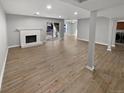 Unstaged Living Room featuring a painted brick fireplace, wood floors, and access to the backyard at 7251 S Xenia Cir # B, Centennial, CO 80112