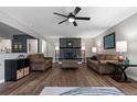 Spacious living room with luxury vinyl flooring, fireplace and ceiling fan at 270 S Chase St, Lakewood, CO 80226