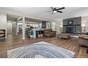 Open concept living room and kitchen features luxury vinyl flooring, ceiling fan and fireplace at 270 S Chase St, Lakewood, CO 80226