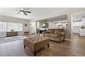Living room features luxury vinyl flooring, a leather couch and an ottoman at 270 S Chase St, Lakewood, CO 80226
