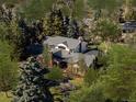Sprawling brick home in wooded, mature neighborhood with plenty of trees and landscaping at 29 Viking Dr, Cherry Hills Village, CO 80113