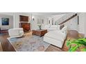 Bright and elegant living room boasts hardwood floors, a large sectional, and classic decor at 29 Viking Dr, Cherry Hills Village, CO 80113