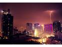 Nighttime view of the city featuring modern architecture and a lightning strike at 891 14Th St # 2205, Denver, CO 80202