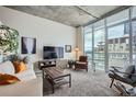 Bright living room with floor-to-ceiling windows showcasing city views at 891 14Th St # 2205, Denver, CO 80202