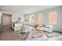 Open-concept living space with hardwood floors, a modern kitchen, comfortable seating, and ample natural light at 1300 N Ogden St # 204, Denver, CO 80218