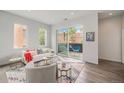 Inviting living room boasts hardwood floors, a cozy sofa, large windows, and access to a charming balcony at 1300 N Ogden St # 204, Denver, CO 80218