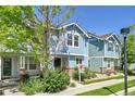 Charming two-story home with blue siding, well-maintained landscaping, and inviting curb appeal at 18947 E 57Th Pl, Denver, CO 80249