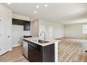 Spacious kitchen with island sink, stainless appliances, and open layout to living room at 4285 Gozzer Ranch Dr, Elizabeth, CO 80107