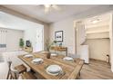 Comfortable dining area with a wooden table and open access to a washer and dryer room at 12143 Melody Dr # 104, Denver, CO 80234