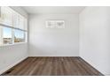 Bright bedroom with a large window providing natural light and beautiful outside views at 27424 E Byers Ave, Aurora, CO 80018