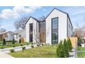 Modern two-story home with light exterior, black trim, rock pathway, and minimalist landscaping at 3047 S Cherokee St, Englewood, CO 80110