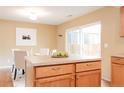 Bright kitchen island and dining area with access to the outdoor space at 654 S Xenon Ct, Lakewood, CO 80228