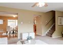View of a neutral living space, looking into dining area and stairway at 654 S Xenon Ct, Lakewood, CO 80228