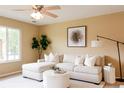 Inviting living room with neutral tones, large window, and modern furnishings at 654 S Xenon Ct, Lakewood, CO 80228