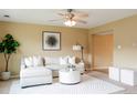 Neutral-toned living room with plush seating and a view into the next room at 654 S Xenon Ct, Lakewood, CO 80228