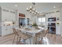 Open kitchen with island seating, stainless steel appliances, and ample white cabinetry at 1193 Highview Ln, Erie, CO 80516