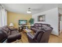Comfortable living room featuring hardwood floors, neutral walls, and plush seating for a cozy gathering space at 1164 W 101St Pl, Northglenn, CO 80260