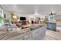 Open-concept living room and dining area with lots of natural light and modern finishes at 6368 S Harlan Way, Littleton, CO 80123