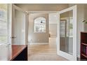 Home office showcases a view into a living space through double french doors for an open feel at 10103 Bluffmont Ln, Lone Tree, CO 80124