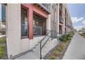Charming townhouse entrance with covered porch, concrete steps, and a well-maintained walkway at 7010 W Alaska Dr, Lakewood, CO 80226