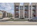 Attractive modern townhome with a mix of brick and siding, enhanced by balconies and professional landscaping at 7010 W Alaska Dr, Lakewood, CO 80226