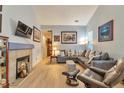 Open living room featuring a gray sectional, comfortable chairs, and natural light at 18619 E Vassar Dr, Aurora, CO 80013