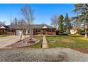 Charming brick home featuring a manicured front yard and inviting walkway at 6755 W 33Rd Ave, Wheat Ridge, CO 80033
