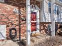 Front door entrance with brick facade and red door at 2169 E 116Th Ave, Northglenn, CO 80233