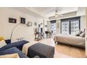Cozy living room featuring modern furnishings, hardwood floors, and large windows with a view of the city at 1750 Wewatta St # 805, Denver, CO 80202
