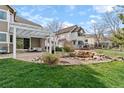 This backyard features a covered patio, rock garden, and space for outdoor seating at 6802 Poppy Ct, Arvada, CO 80007