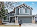 Charming gray two-story home with well-maintained landscaping and a two-car garage, offering curb appeal at 9208 W 100Th Pl, Broomfield, CO 80021