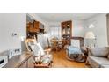 Comfortable living room and dining area with hardwood floors and a built-in hutch at 6167 Newland St, Arvada, CO 80003