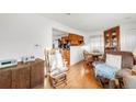 Cozy living room flows into the dining area, perfect for entertaining at 6167 Newland St, Arvada, CO 80003