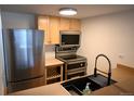Updated kitchen featuring stainless steel appliances and light wood cabinets at 200 N Pearl St # 205, Denver, CO 80203