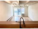 Bright living room with hardwood floors and a modern light fixture at 200 N Pearl St # 205, Denver, CO 80203