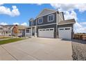 Inviting exterior of a two-story home with an attached three car garage and green front yard at 1038 Scotts Peak Dr, Berthoud, CO 80513