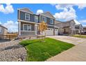 Charming home featuring a well-kept lawn, rock landscaping, and a convenient three-car garage at 1038 Scotts Peak Dr, Berthoud, CO 80513
