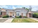 Welcoming townhome exterior with brick accents and manicured landscaping at 1748 Eagle St # B, Aurora, CO 80011