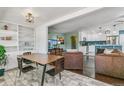 Bright dining area with built-in shelving and hardwood floors at 172 S Lowell Blvd, Denver, CO 80219