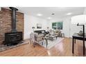 Bright living room with hardwood floors, brick fireplace, and neutral-toned furniture creating a cozy atmosphere at 981 Ursula St, Aurora, CO 80011