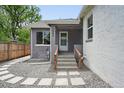 Charming home exterior featuring a gray brick facade, stone walkway, and freshly painted accents at 3344 W 33Rd Ave, Denver, CO 80211