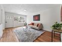 Inviting living room features hardwood floors, a large window, and neutral decor for a cozy ambiance at 3344 W 33Rd Ave, Denver, CO 80211
